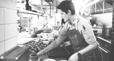 Female chef Bonnie Morales plating food orders.