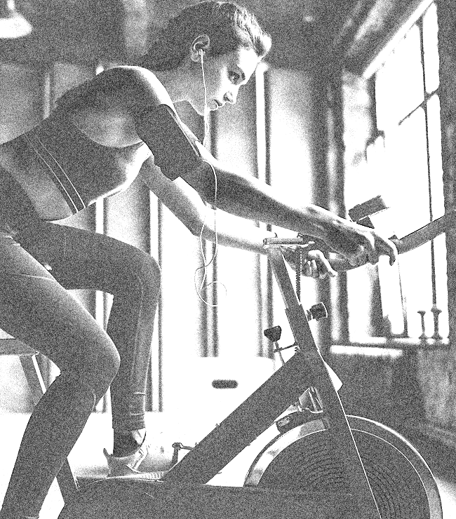 Young woman on an exercise bike.