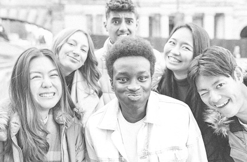 Diverse group of young adults showing different emotions to the camera.