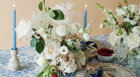 Bloomshakalaka ivory flower centerpiece arrangement on a table at a dinner party.